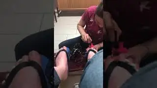 Guy getting pedicure with nail polish