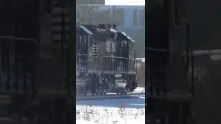 Pair of Norfolk, Southern SD40-2 engines Go through the snow.