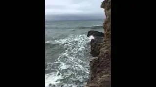 Cliff Caves and the Stormy Sea