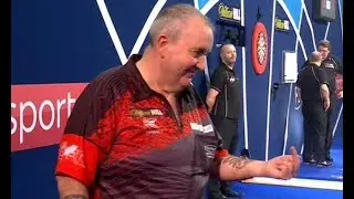 Phil Taylor flips middle finger and Rob Cross drops gla ss