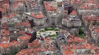 High altitude view of central Bilbao featuring Plaza Moyua distinctive circular design, surrounded
