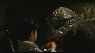 Baby Godzilla eating a burger