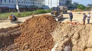 Process repair road in village use Komatsu d41 pushing soil rock with heavy dump truck 