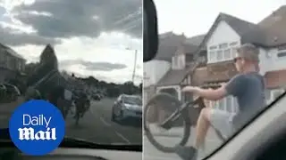 Moment reckless cyclists perform dangerous stunts on main road - Daily Mail