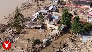 Aerial footage shows Indonesian flood devastation as ruined infrastructure delays aid