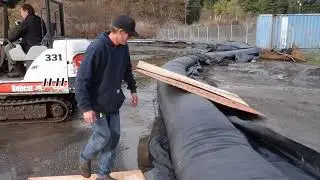 Driving an Excavator over an AquaDam