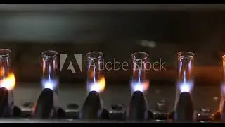 Stock video: glass ampoule vial making process using fire in a pharmaceutical production factory.