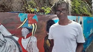 The face behind Grenadas famous murals, and he knows he African 1st....