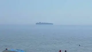 The Ghost ship slips through,  humidity and Cackle, of beachers beaching.