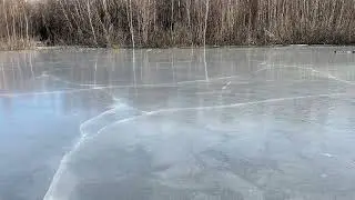 Cracking ice on pond due to thermal conditions