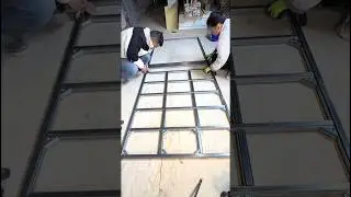 Workers Assemble a Metal Stud Frame