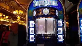 Silver Strike slot machine dispensing a token