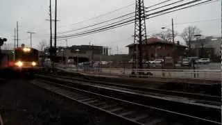 An eastbound M7 express train bypasses Mineola