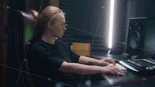 Female audio engineer creates song with modern musical equipment