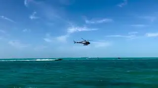 Helicopter pacing race boat