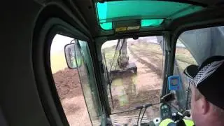 volvo 290 with rotortilt stripping topsoil.