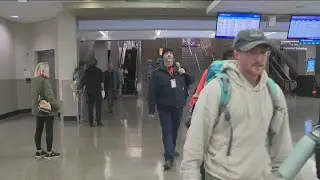 Families, friends share hugs and greetings arriving at Des Moines International Airport ahead of Tha