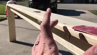 Behind the couch shelf with 2 outlets