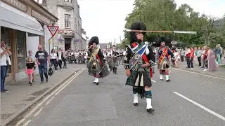 Mace flourish as Drum Majors lead the combined pipe bands back after 2023 Ballater Highland Games