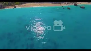 Aerial over beautiful blue Mediterranean ocean waters reveals Greek Island of Lefkada