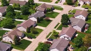 Peaceful aerial view of a suburban neighborhood in the usa. Neat houses and green lawns perfect