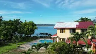 Aerial shot of a house with a private pool in the coastal area. A beautiful two-story house for