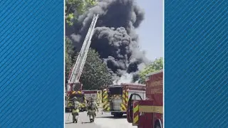 Huge plumes of smoke from housefire are seen behind first-responders in video from neighbor