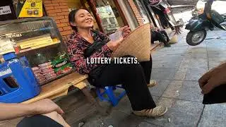 Helping a humble woman in Hanoi.