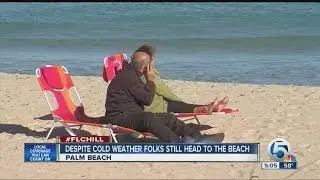 Despite cold weather folks still head to the beach