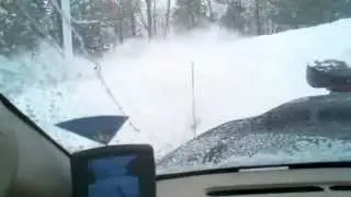 Pickup truck plowing snow with high wind rows