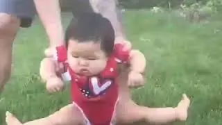 Funny baby reaction on grass