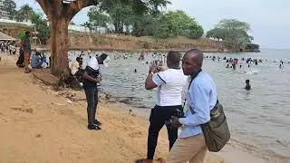 Young people swimming in crocodile infested waters of lake Victoria at Aero beach ENTEBBE Uganda.