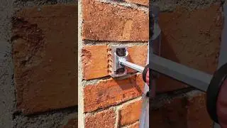 Using a slotting tool to cut grooves in the brick wall
