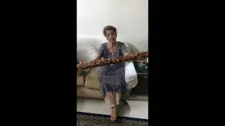 Senior citizen playing  a Rain Stick