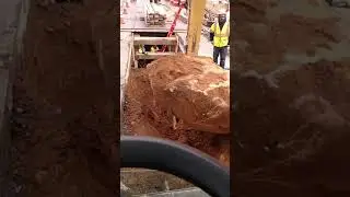 Cat 316 pulling big rock