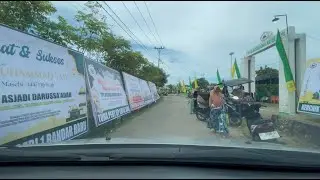 A rural road in Indonesia, with an event taking place along the roadside