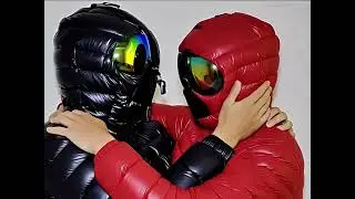 Lovely girl in a zippered hood. Closable hood-mask. Red down jacket with glasses on the hood.