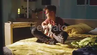 video preview h264 8 Teenager Playing Guitar Near Amplifier