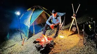 Camping alone one night on the mountain cooking BBQ to eat and see the sunset