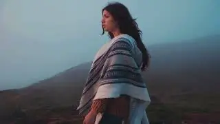 Incredible GORGEOUS woman Wandering through the FLowered Mountain meadow surrounded by GREEN