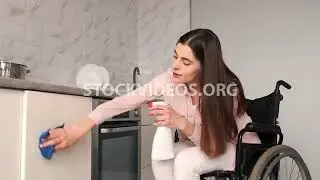 woman in wheelchair cleaning surfaces in...
