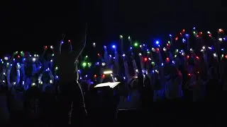 This choir is amazing! A Sky Full of Stars performance with finger lights.