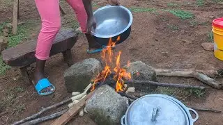 African village life. Cooking African delicious meal. Rainy day grazing