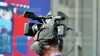Moscow, Russia - July 5, 2025: Videographer recording sport event with professional camcorder