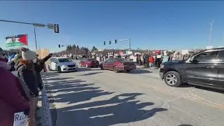 Large crowd of protesters gathered in Clive ahead of Presidential visit