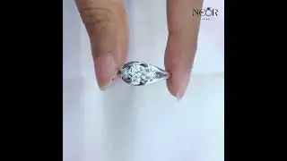 Moissanite engagement ring with brilliant round-cut center stone and sparkling pav&eacute; details