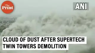 Cloud of dust engulfs area around Supertech Twin Towers after the demolition