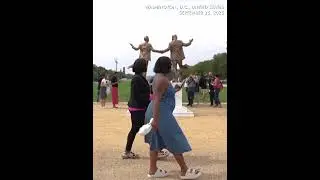 Pop-up statue of Trump and Epstein draws crowd near US Capitol