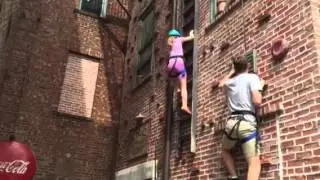 Jessie climbs wall at universal studios