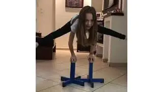 Acrobatic gymnastics stands workout by a 8 year old during corona quarantine daily practice